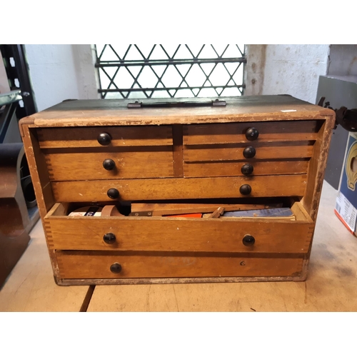 3063 - An oak engineers cabinet fitted with eight various drawers containing a full and unsorted collection... 