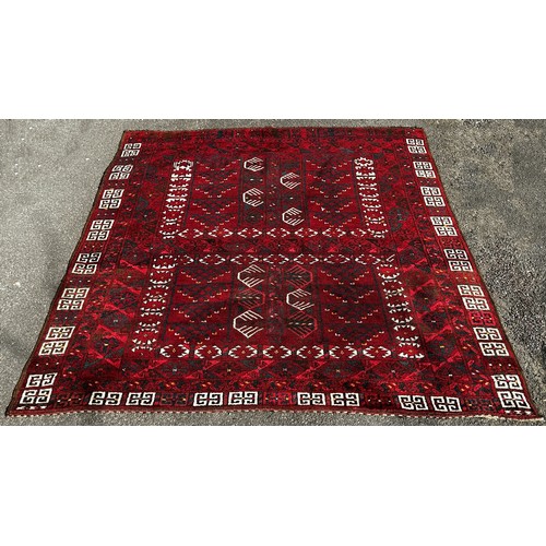 2708 - A Turkish Persian design carpet, with an all over intricate geometric pattern on a predominantly red... 