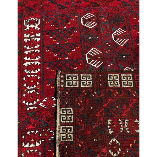 2708 - A Turkish Persian design carpet, with an all over intricate geometric pattern on a predominantly red... 