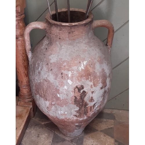 3011 - A terracotta storage jar with simple lug handles, 60cm high