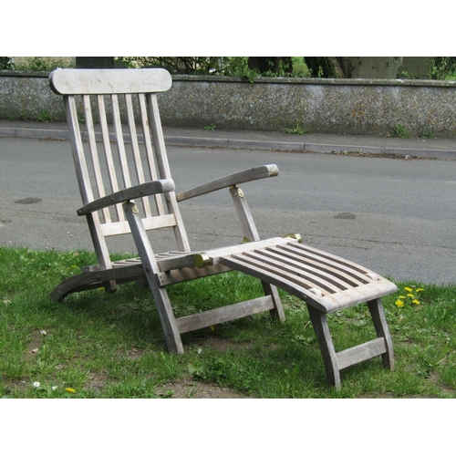 696 - A Cotswold teak weathered folding steamer type lounge chair with slatted seat, back and foot rest