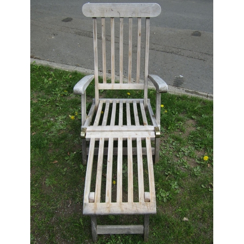 696 - A Cotswold teak weathered folding steamer type lounge chair with slatted seat, back and foot rest