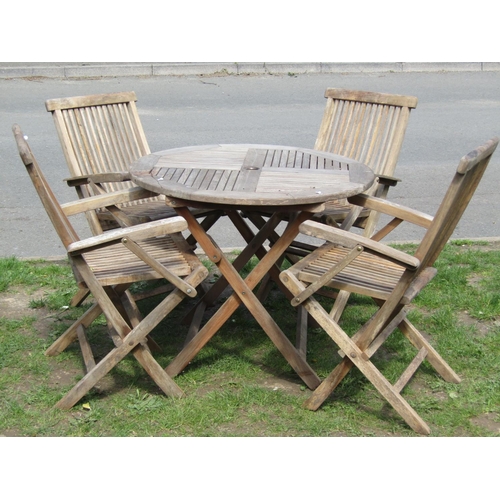 698 - A weathered hardwood five piece folding garden terrace set comprising circular top table 90 cm diame... 