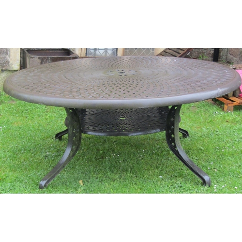 711 - A large heavy gauge cast alloy circular garden table with decorative pierced lattice top, 180 cm dia... 