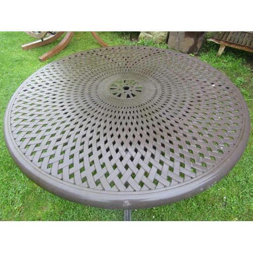 711 - A large heavy gauge cast alloy circular garden table with decorative pierced lattice top, 180 cm dia... 