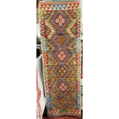 2680 - A Chobi Kilim runner with six connected multi coloured zig-zag diamonds, 195cm x 64cm approx.