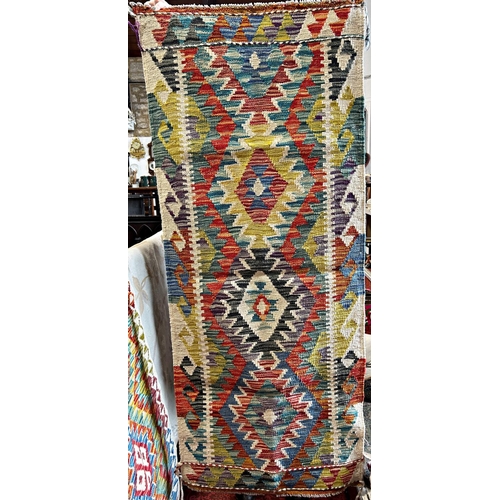 2682 - A Chobi Kilim runner with a central row of three multi coloured diamonds, 158cm x 64cm approx.