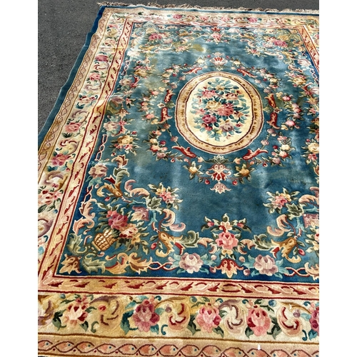 2694 - A large 18th century style thick pile wool carpet in the Neoclassical style of a floral pattern on a... 