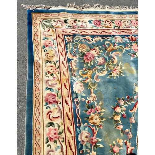 2694 - A large 18th century style thick pile wool carpet in the Neoclassical style of a floral pattern on a... 