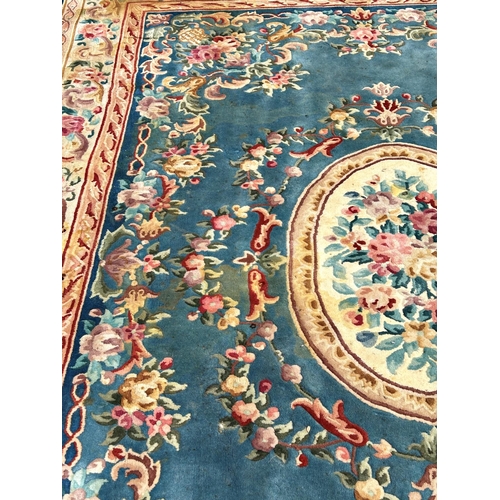 2694 - A large 18th century style thick pile wool carpet in the Neoclassical style of a floral pattern on a... 