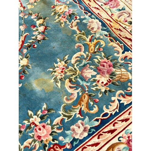 2694 - A large 18th century style thick pile wool carpet in the Neoclassical style of a floral pattern on a... 