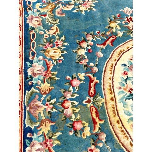 2694 - A large 18th century style thick pile wool carpet in the Neoclassical style of a floral pattern on a... 