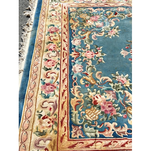 2694 - A large 18th century style thick pile wool carpet in the Neoclassical style of a floral pattern on a... 