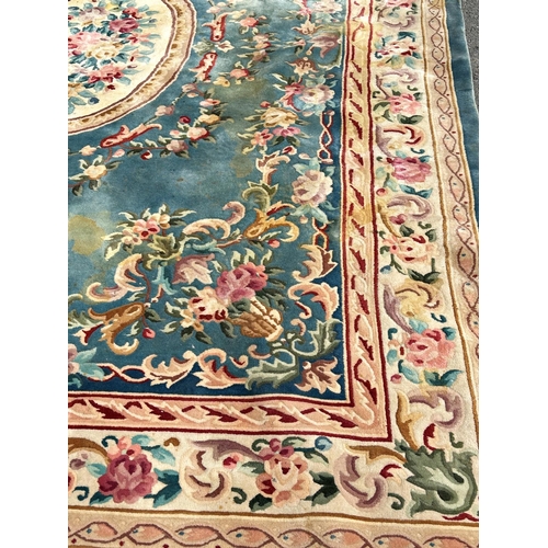 2694 - A large 18th century style thick pile wool carpet in the Neoclassical style of a floral pattern on a... 