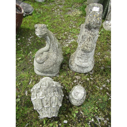 213A - A weathered cast composition stone Easter Island head garden ornament 50 cm high together with one o... 