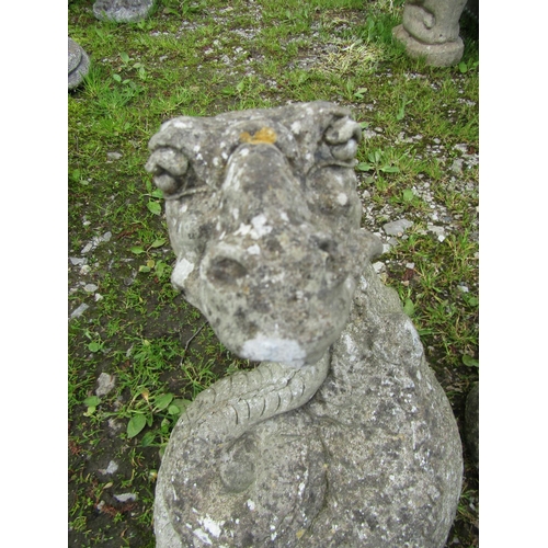 213A - A weathered cast composition stone Easter Island head garden ornament 50 cm high together with one o... 