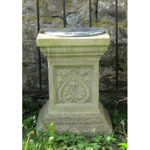 727 - A weathered contemporary garden sun dial, the circular cast iron plate with humming bird gnomon rais... 