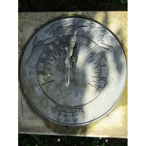 727 - A weathered contemporary garden sun dial, the circular cast iron plate with humming bird gnomon rais... 