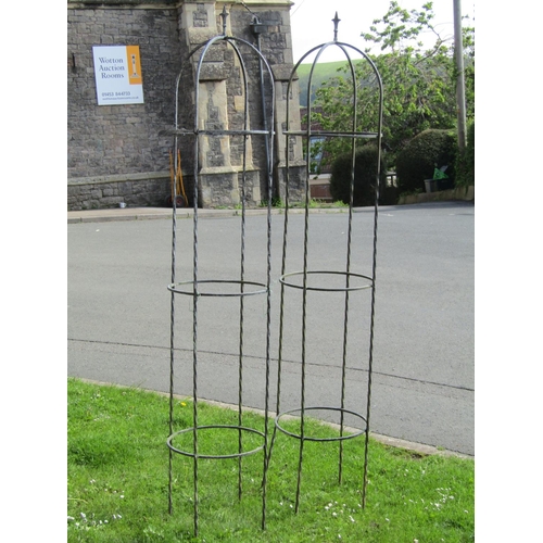 721 - A pair of weathered galvanised steel garden obelisks with twisted rod and ring construction forming ... 