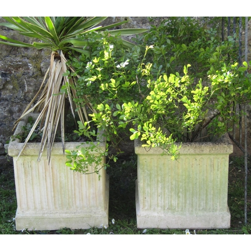 724 - A pair of weathered cast composition stone garden planters of square fluted form, 46 cm square (plan... 