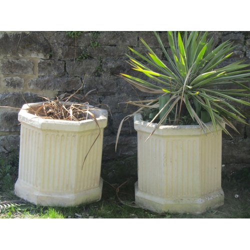 729 - A pair of weathered cast composition stone octagonal garden planters with fluted detail 50 cm wide x... 