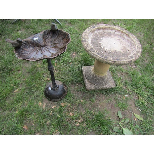 692 - A weathered cast composition stone two sectional bird bath of circular form raised on baluster pedes... 