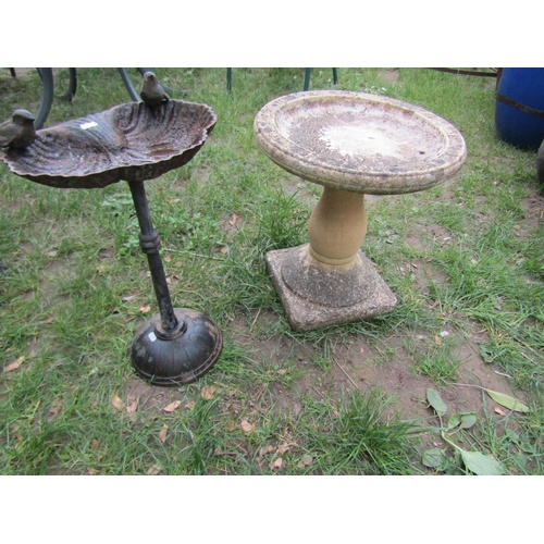 692 - A weathered cast composition stone two sectional bird bath of circular form raised on baluster pedes... 