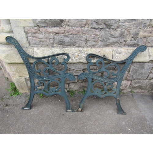 710 - A pair of cast iron bench ends with bound scroll detail