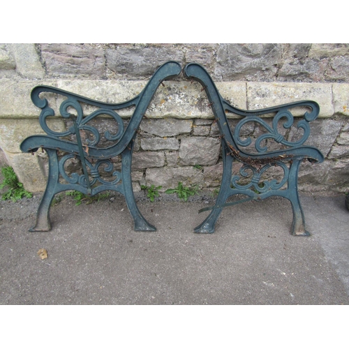 710 - A pair of cast iron bench ends with bound scroll detail