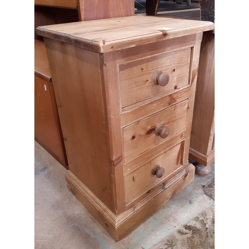 3099A - A small stripped pine chest of three drawers