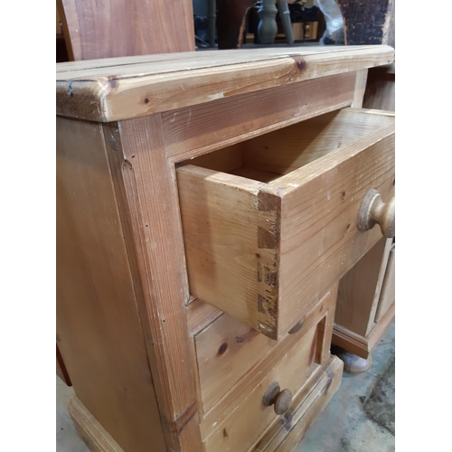 3099A - A small stripped pine chest of three drawers