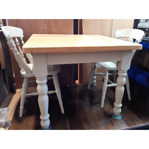 3100 - A contemporary pine kitchen table on painted supports 90 cm square together with a set of four Winds... 