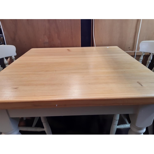 3100 - A contemporary pine kitchen table on painted supports 90 cm square together with a set of four Winds... 