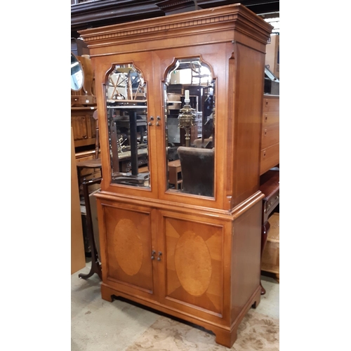 3113 - A good quality cabinet in the Georgian style, the lower section enclosed by two panelled doors, the ... 