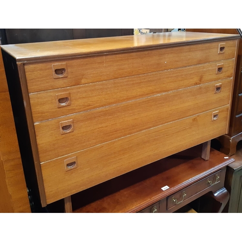 3114 - A mid century teakwood chest of four long graduated drawers by Alfred Cox 108 cm wide