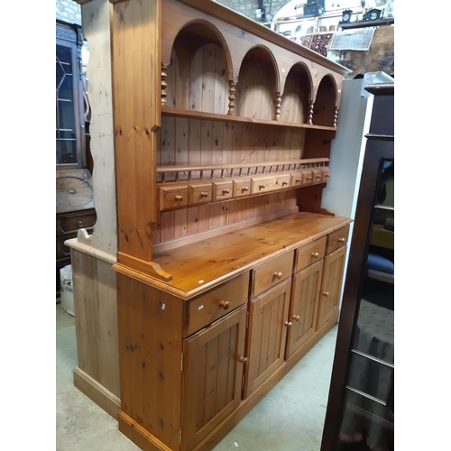 3136 - A Cotswold collection pine dresser of traditional form enclosed by four long cupboards and four draw... 