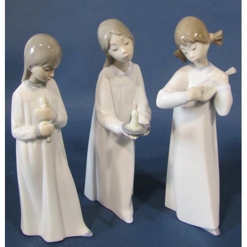 2101 - A large collection of Lladro figures to include three nuns, children in various poses, girl carrying... 