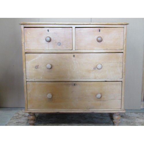 3125 - A stripped and waxed pine chest of two long and two short drawers on turned supports, 92 cm wide