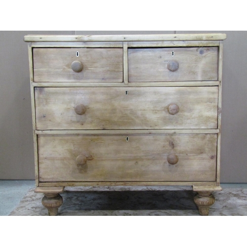 3126 - A stripped pine chest of two long and two short drawers on turned supports