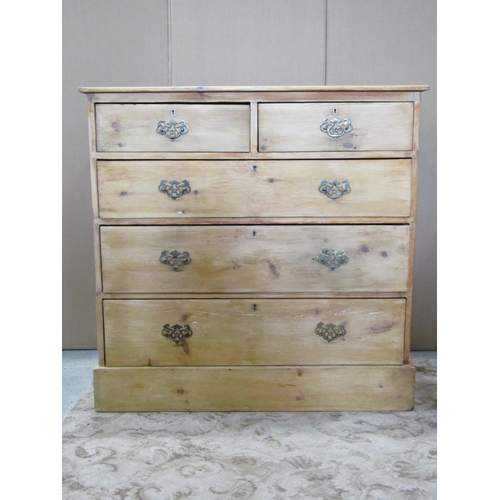 3127 - A pine chest of three long and two short drawers on a plinth base with stripped finish