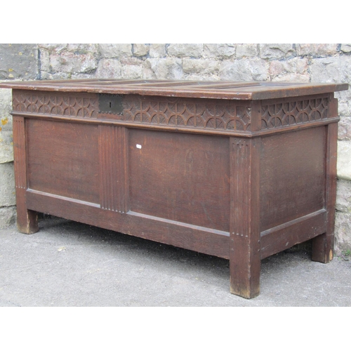 3536 - A simple honest early 18th century oak coffer, the front elevation enclosed by two panels beneath a ... 