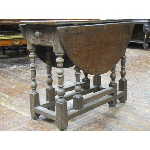 3544 - 18th century oak cottage dining table on eight turned supports, with frieze drawer, 90cm long