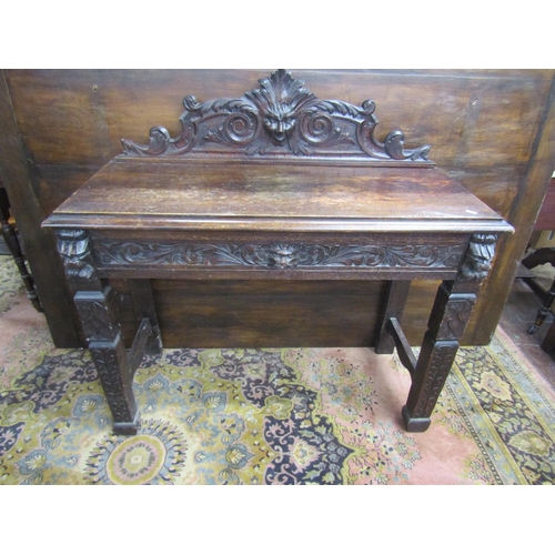 3547 - A Victorian oak hall table with frieze drawer on square cut supports, with green man, lion mask, and... 