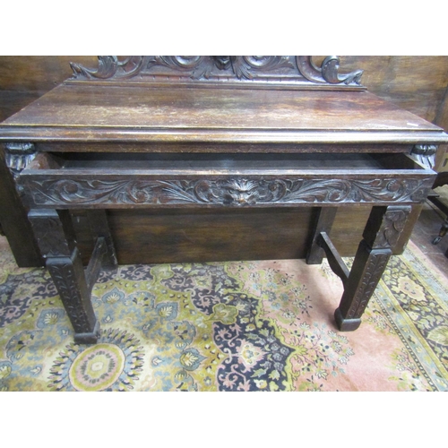 3547 - A Victorian oak hall table with frieze drawer on square cut supports, with green man, lion mask, and... 