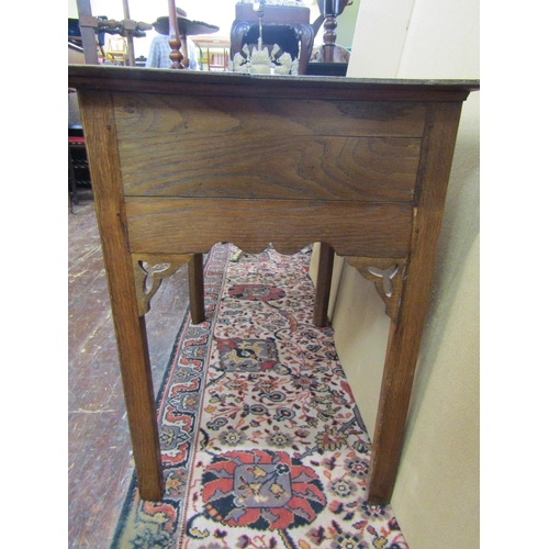 3551 - A Georgian oak cottage lowboy fitted with three frieze drawers within a shaped apron on square mould... 