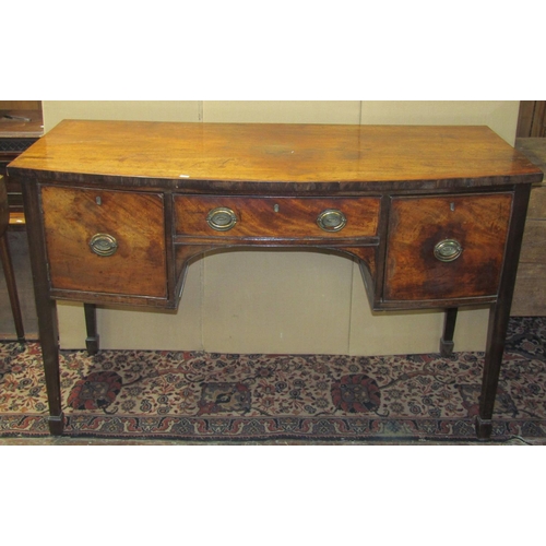 3572 - A Georgian mahogany bow fronted sideboard, the central drawer flanked by a cupboard and cellarette o... 