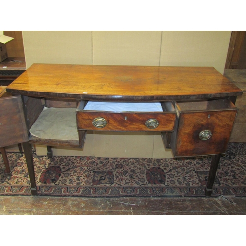 3572 - A Georgian mahogany bow fronted sideboard, the central drawer flanked by a cupboard and cellarette o... 