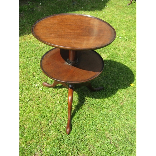 3583 - A Georgian mahogany two tier waiter on turned pillar and tripod base