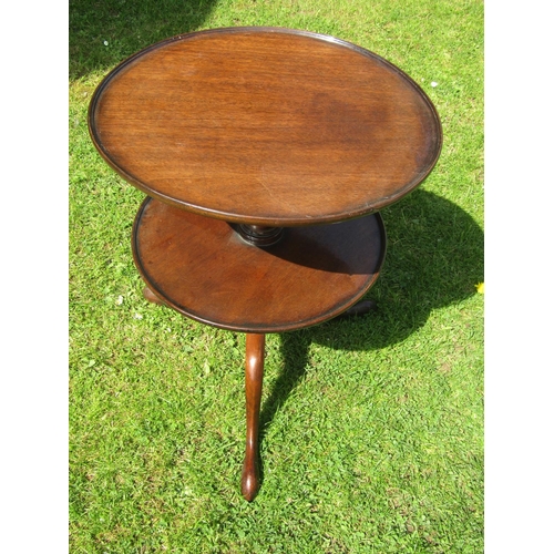 3583 - A Georgian mahogany two tier waiter on turned pillar and tripod base