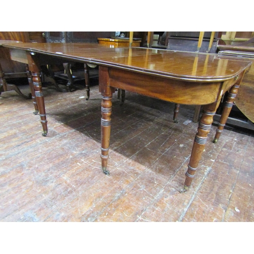 3584 - A Georgian mahogany D end dining table with central leaf raised on eight turned supports (can be use... 